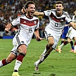 Germany’s Mario Götze (left) celebrates with Thomas Muller after scoring the winning goal during ext